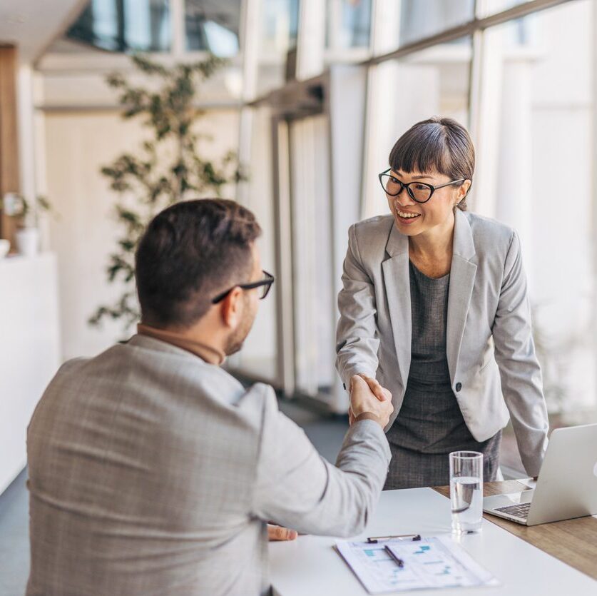 an attorney shaking the hand of her client